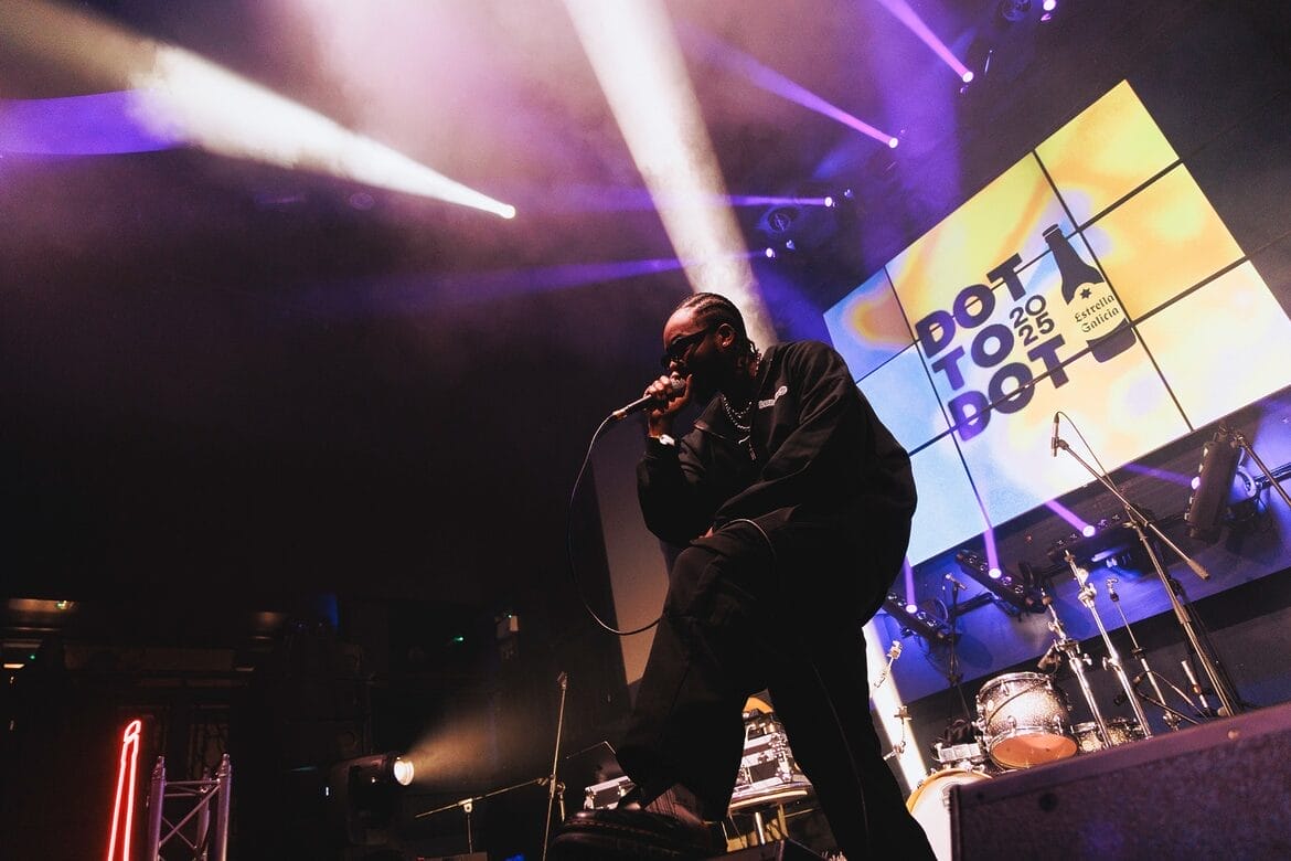 Dot to Dot artist on stage with logo sign behind